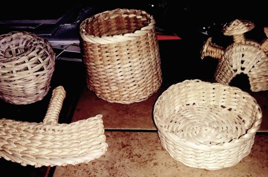 baskets, helmet, and fan made with ʻieʻie